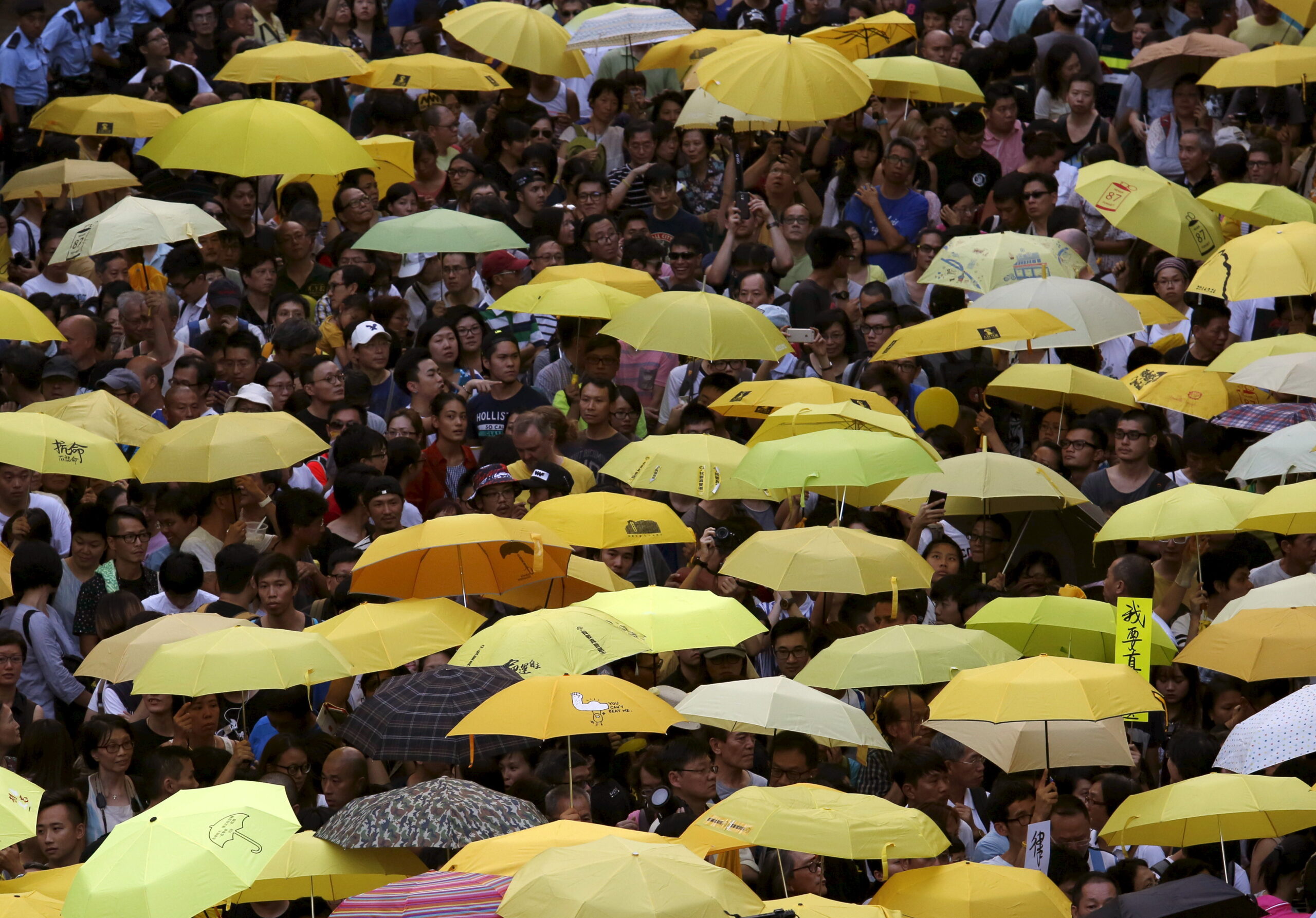Pro-democracy protesters carrying yellow umbrellas, symbol of the Occupy Central civil disobedience movement, gather outside government headquarters in Hong Kong